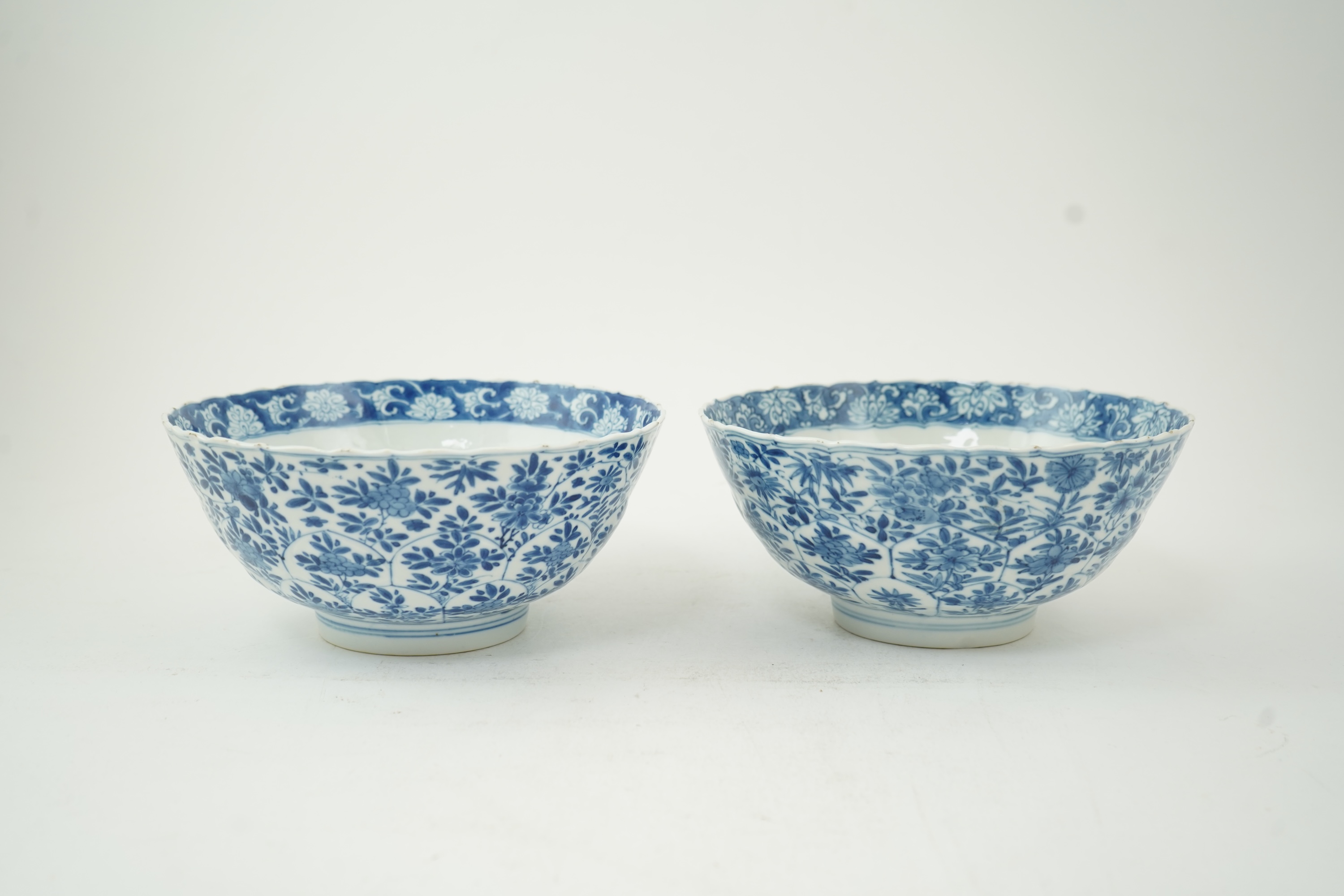 A near pair of Chinese blue and white lotus flower moulded bowls, Kangxi period